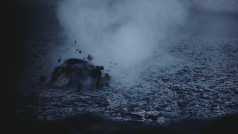 mud bubbles exploding and releasing steam in geothermal pool