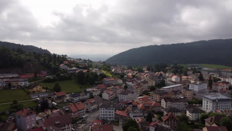 Aerial-shot-above-buildings-in-Sainte-Croix,-Switzerland-on-a-cloudy-day
