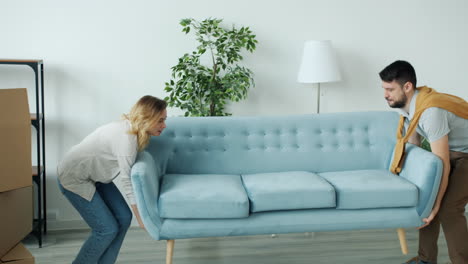 couple moving into their new home and relaxing on the sofa