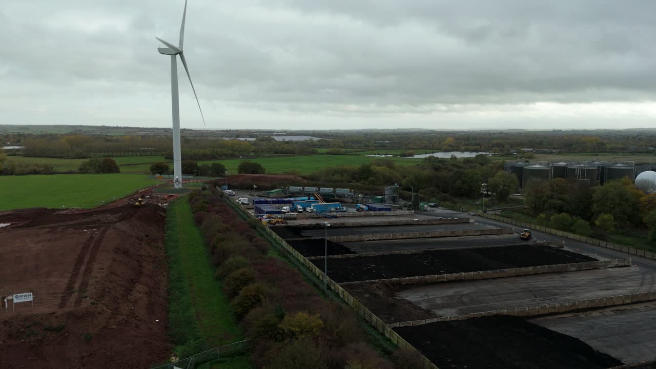 Aerial drone view of wind turbine and water treatment plant infrastructure showing industrial and renewable energy systems near Leicester United Kingdom