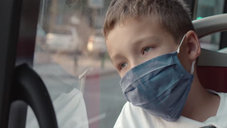 child in mask having boring bus travel