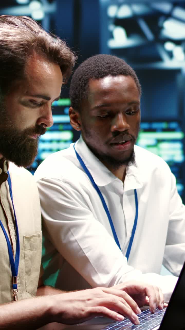Vertical video Colleagues running data center tests