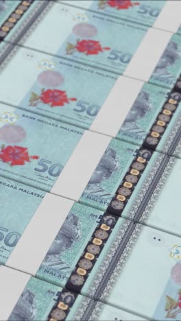 vertical video of 500 malaysian ringgit banknotes printed by a money press