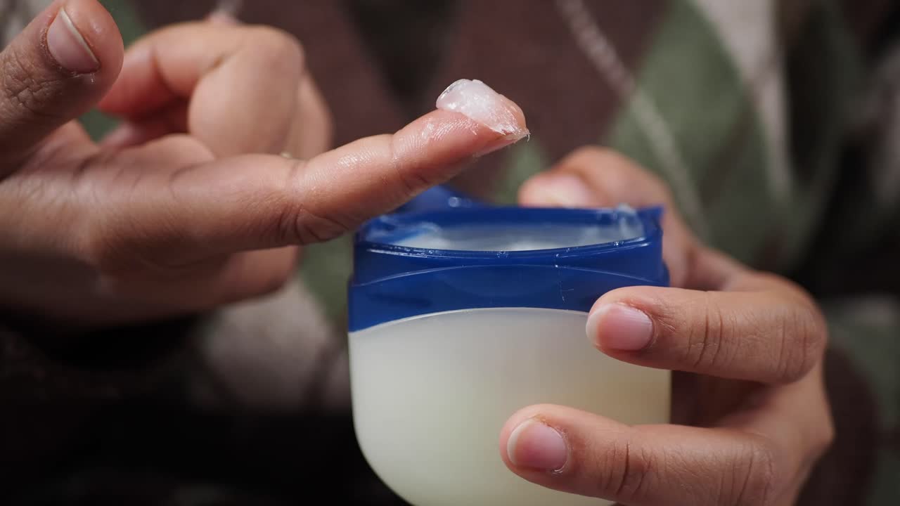 Close Up of Hand with Petroleum Jelly on Finger