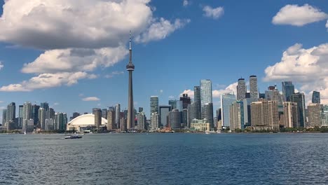 epic toronto hyperlapse of downtown city skyline with clouds around cn tower and boats in busy harbour