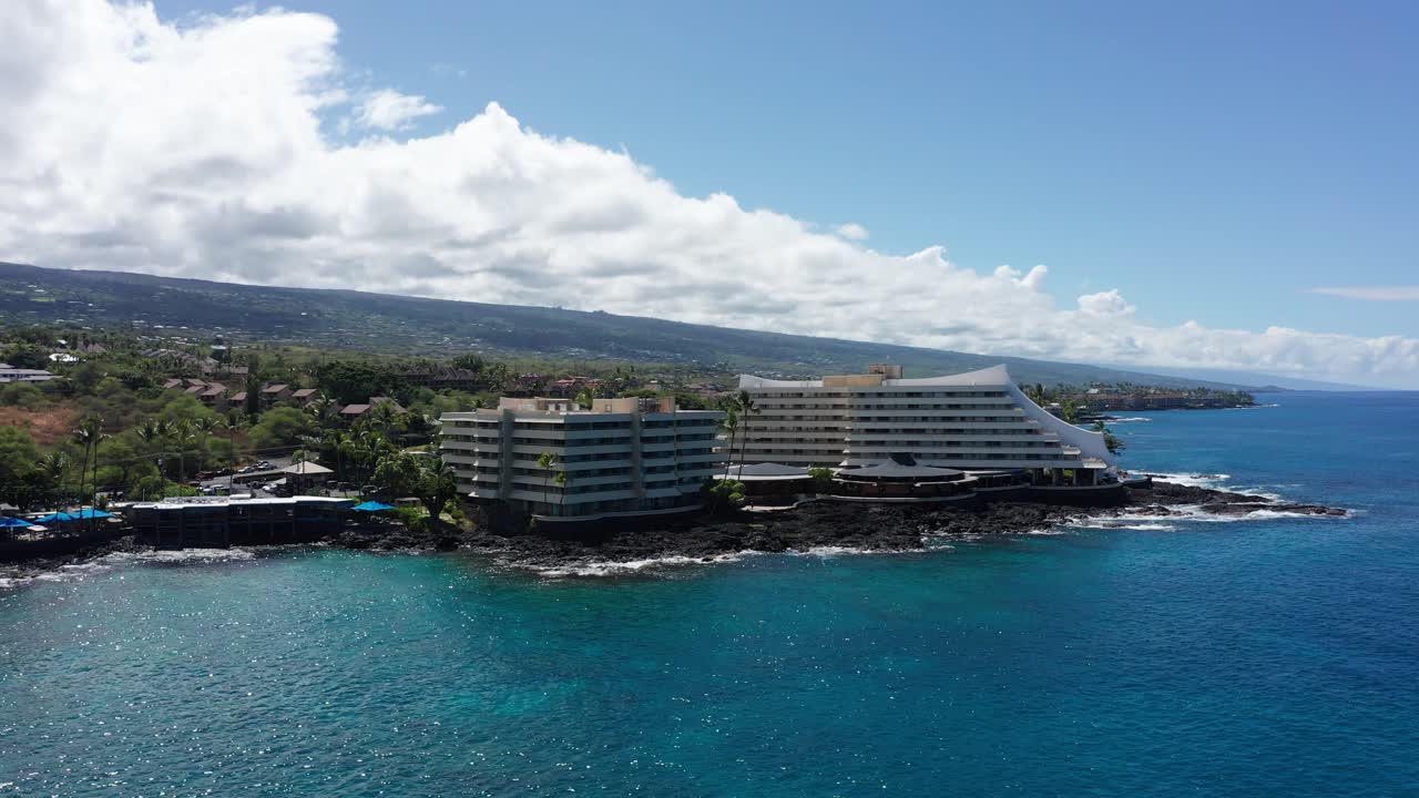 Low panning aerial shot of the Royal Kona resort along the coast of Kailua-Kona in Hawai'i