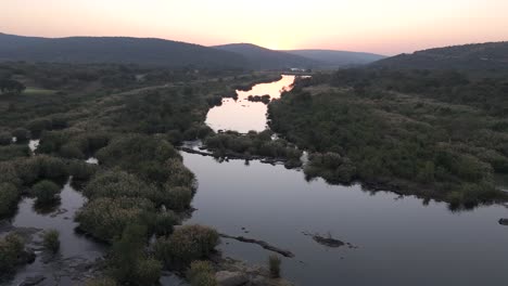 Panoramic-forward-aerial-along-Komati-River-and-bushveld-in-South-Africa-during-sunrise