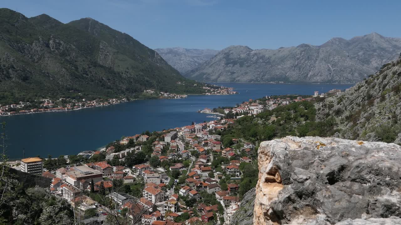 Kotor Bay, cinematic reveal shot behind stone wall, Kotor Town, Montenegro