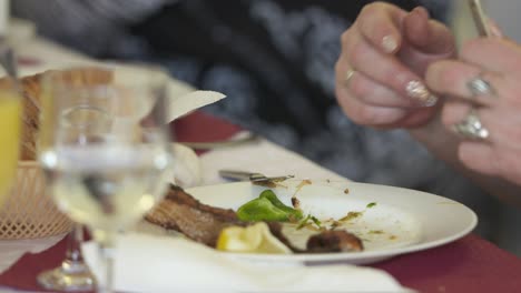 people enjoying meal at festive dinner table in restaurant closeup