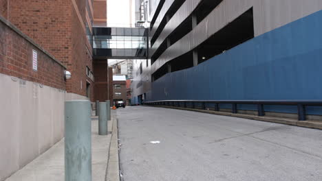empty alley between a parking garage and hospital with sky bridge in center city philadelphia