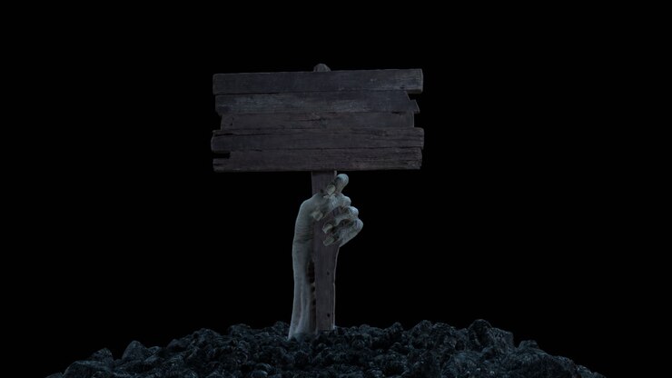 A zombie hand with a wooden sign crawls out of the ground with alpha channel