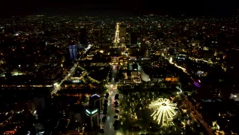 tirana seen from above at night, the illuminated buildings, the boulevard, the hotels, the pyramid, the palace of congresses, the capital of albania with a drone view