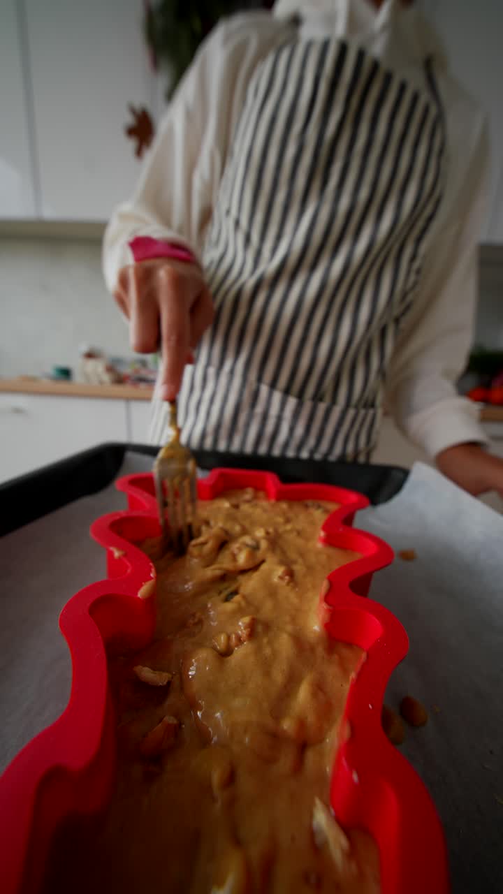 Person Mixing Cake Batter in Red Christmas Tree Mold