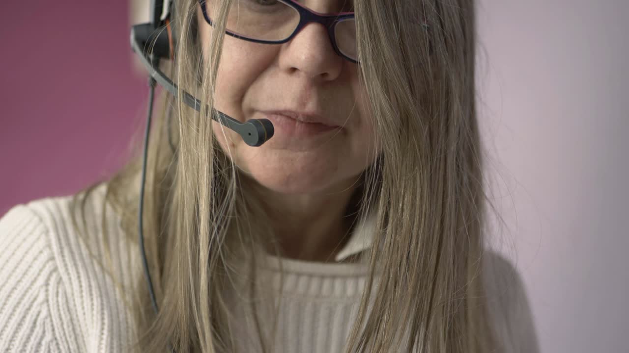 Woman wearing headset talking to customer medium shot