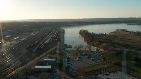 aerial shot of parking lot and docks by water at sunrise