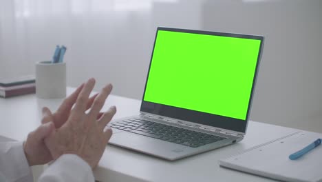 laptop with chroma key screen on table of doctor in office of clinic, videochat concept