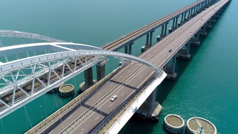 aerial view of a bridge over water with highway and train tracks