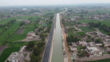 Aerial-View-of-Road-Construction-on-the-Stream's-Bank