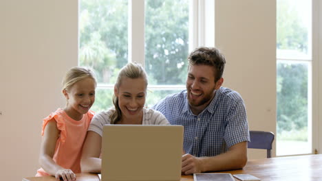 Una-Familia-De-Tres-Está-Usando-Una-Computadora-Portátil