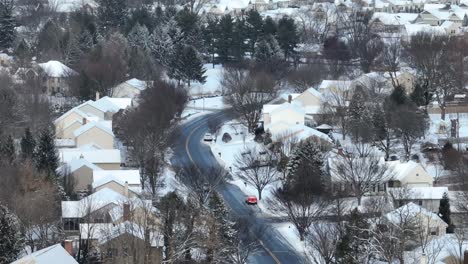 Cars-on-snowy-hill-road-of-American-neighborhood