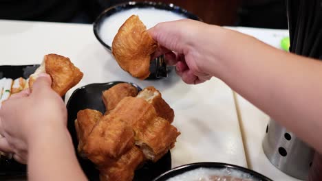 hands preparing traditional deep-fried dough sticks