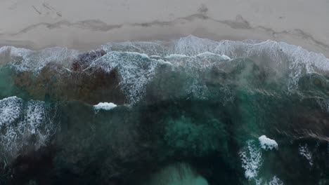 Wellen-Schlagen-An-Den-Strand-Und-Wirbeln-Sand-Unter-Der-Oberfläche-Auf