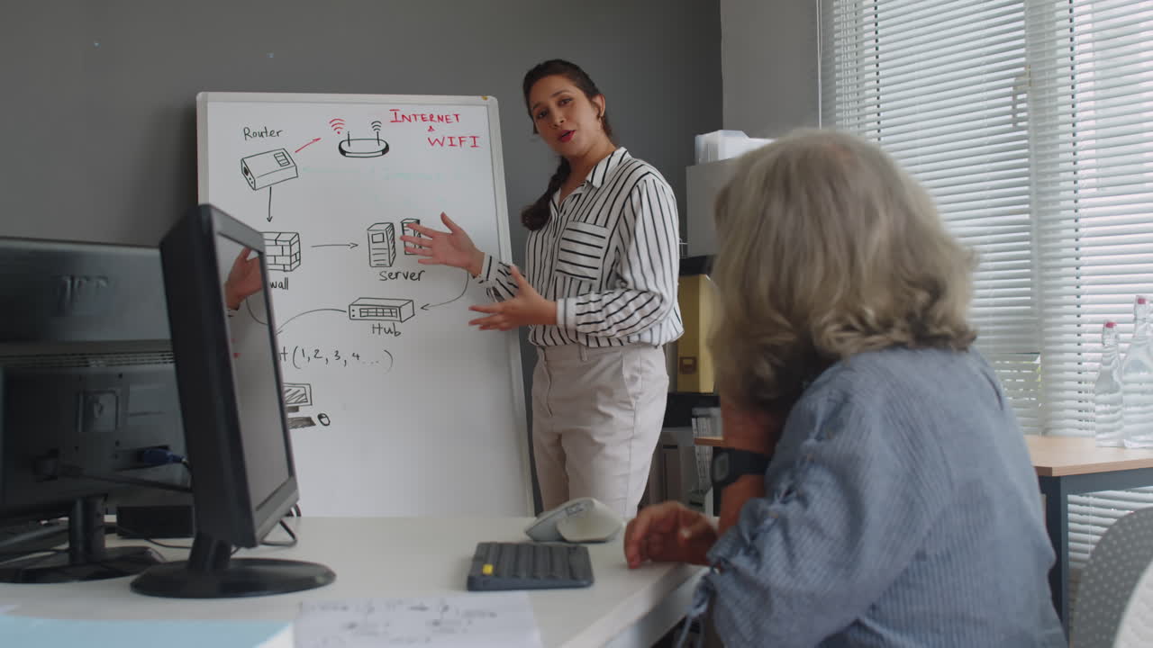 Mature Woman Learning to Type Text on Keyboard of Computer during Lesson