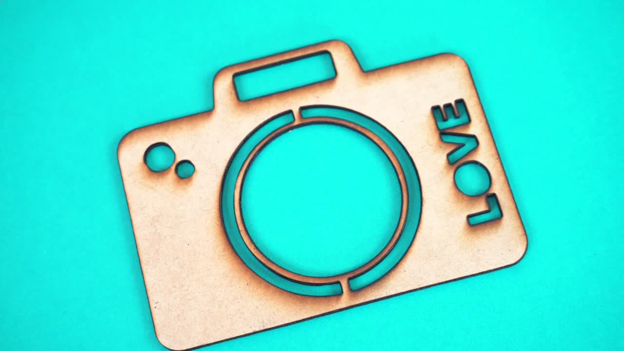 MDF camera cutout with 'LOVE', showcasing craft and creativity