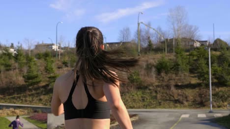 young woman out running gimbal tracking shot slow motion