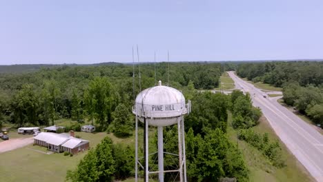 Pine-Hill,-Alabama-water-tower-with-drone-video-pulling-back