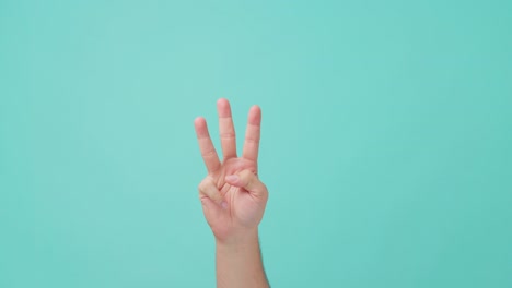 close up shot of human hand raising, making hand gesture counting down number by fingers. the man making a semaphore or a sign by using his palm hand. seen in isolate blue screen in background.