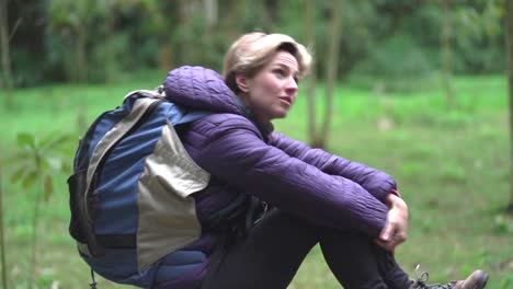 woman sitting in forest enjoying fresh air