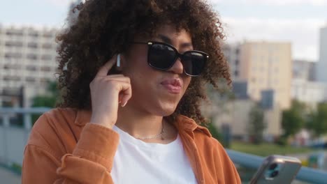 Black-woman-standing-on-the-bridge-and-having-a-video-call