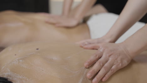 Männer-Und-Frauen-Genießen-Eine-Massage-Im-Spa-Bei-Einer-Luxusmassage-Durch-Professionelle-Therapeuten,-Eine-Vitalisierende-Ölpeeling-Massage-Für-Ein-Paar-Oder-Eine-Traditionelle-Thai-Wellnessmassage-Für-Paare