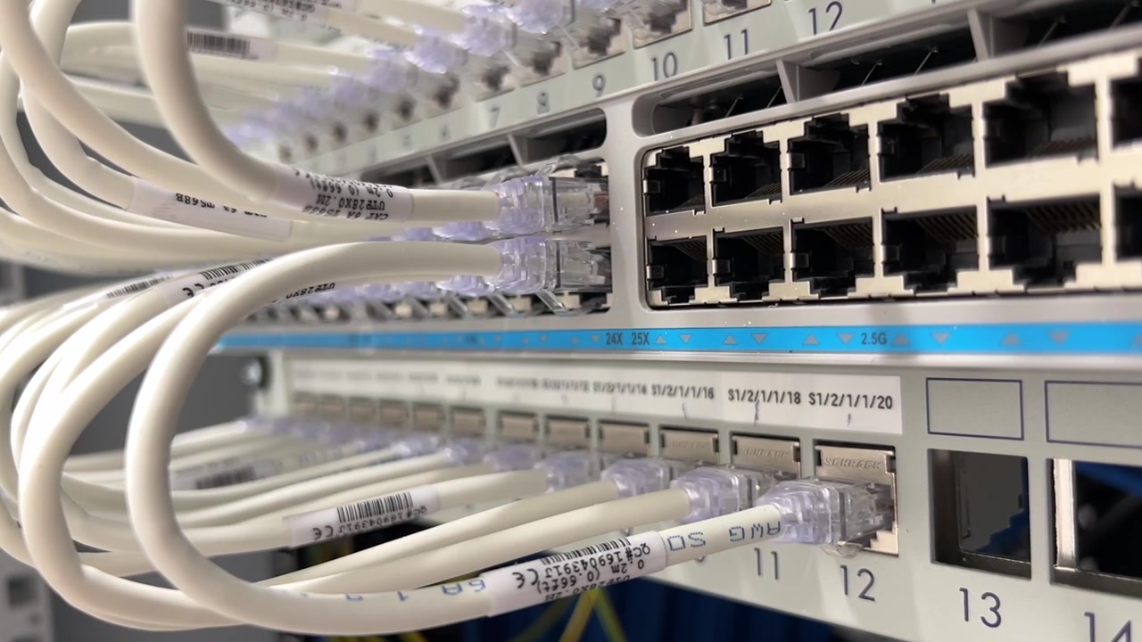 IT rack with close up to the switch and patch panel. You can see red and free ports