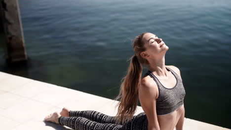 morning sun yoga stretches at beach bay barcelona