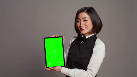 Asiatische-Restaurant-Hostess-Zeigt-Greenscreen-Display-Im-Studio