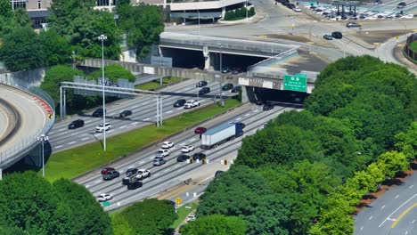 cars and semi-trailer trucks driving through interstate highways in atlanta, georgia. - wide shot