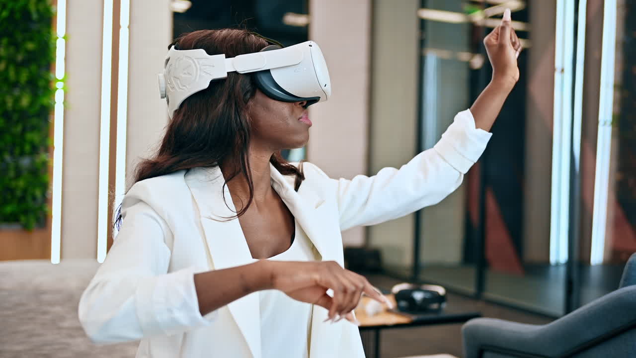 A black woman exploring virtual reality using VR glasses in an office