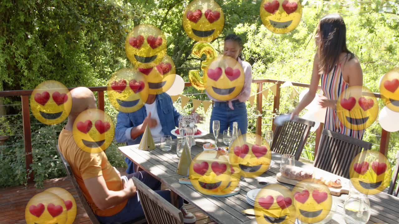 Women carrying cake on deck presenting to birthday man, emoji overlays hiding faces for 30th event