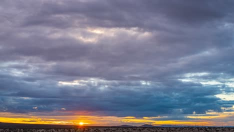 golden sunrise dawns over the arid landscape of the mojave desert basin - wide angle time lapse