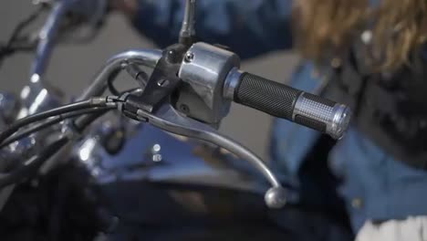 female hands on motorcycle steering wheel