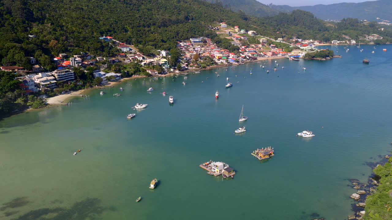 Drone orbiting over Caixa D’aço Beach with anchored boats in Porto Belo, Santa Catarina, Brazil