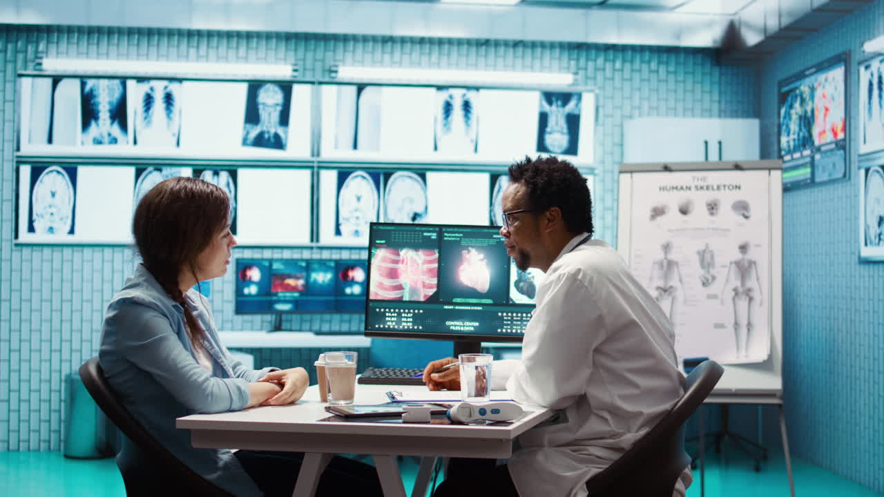 Medical specialist showing the internal organs scans to woman in cabinet