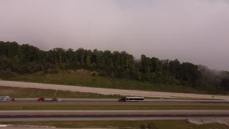 Semi-trailer-Trucks-Driving-At-I-75-Highway-In-The-Mountains-Of-Tennessee---Rarity-Mountain-Road---aerial-tracking-shot