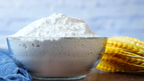 flour in a glass bowl with wheat ears