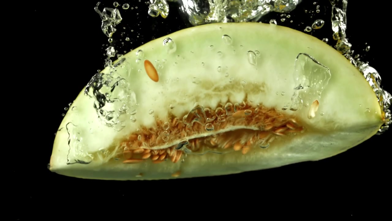 Fresh Melon Slice Submerged in Water with Bubbles