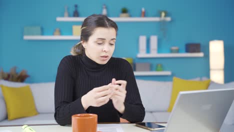 Attention-young-entrepreneur-woman-working-in-home-office-talking-with-friend-on-facetime.