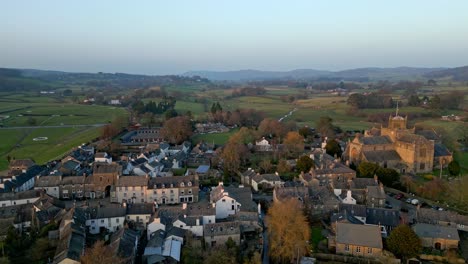 Aerial-footage-of-the-Medieval-village-of-Cartmel-in-the-English-Lake-District-it-has-a-rich-heritage,-and-varied-list-of-activities-for-visitors-and-tourists