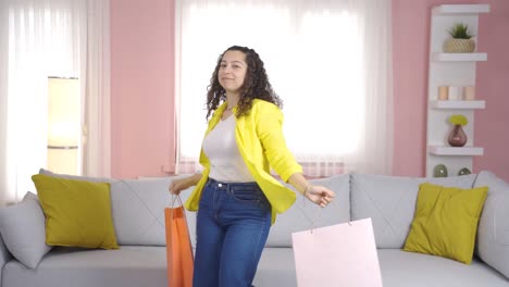 Dancing-young-woman-with-shopping-bags.